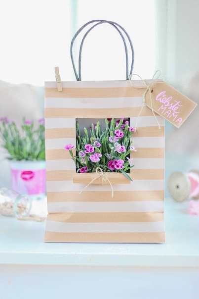 Geschenktüte mit einem eingeschnittenen Fenster, durch das man die Pink Kisses in der Tüte sehen kann